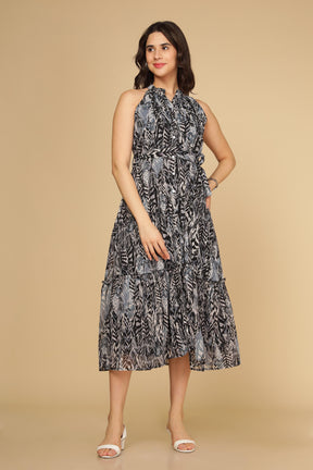 Black halter neck maxi dress with tiered design and modern print.