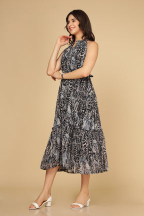 Black halter neck maxi dress with floral pattern and tiered design.