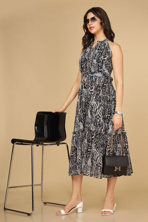 Elegant black halter neck maxi dress styled with accessories.