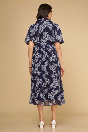 Navy floral pleated maxi dress back view with elegant details.