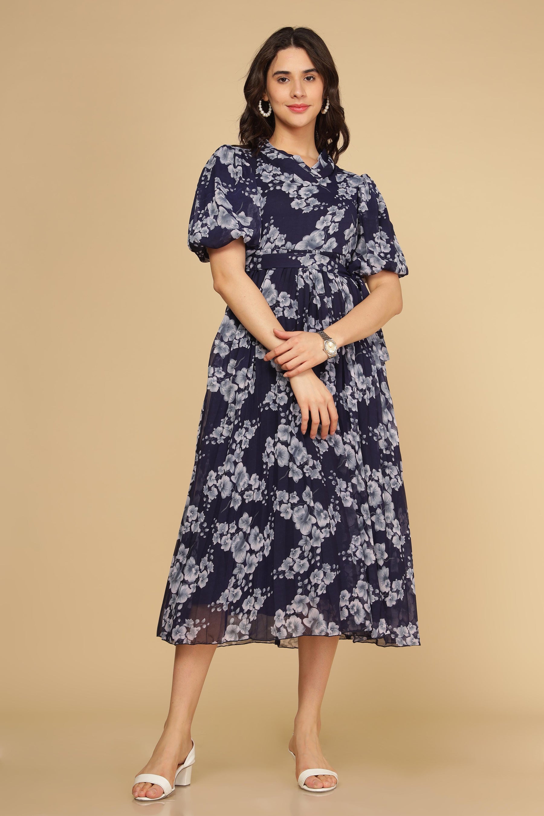 Navy floral pleated maxi dress on a model with sandals.