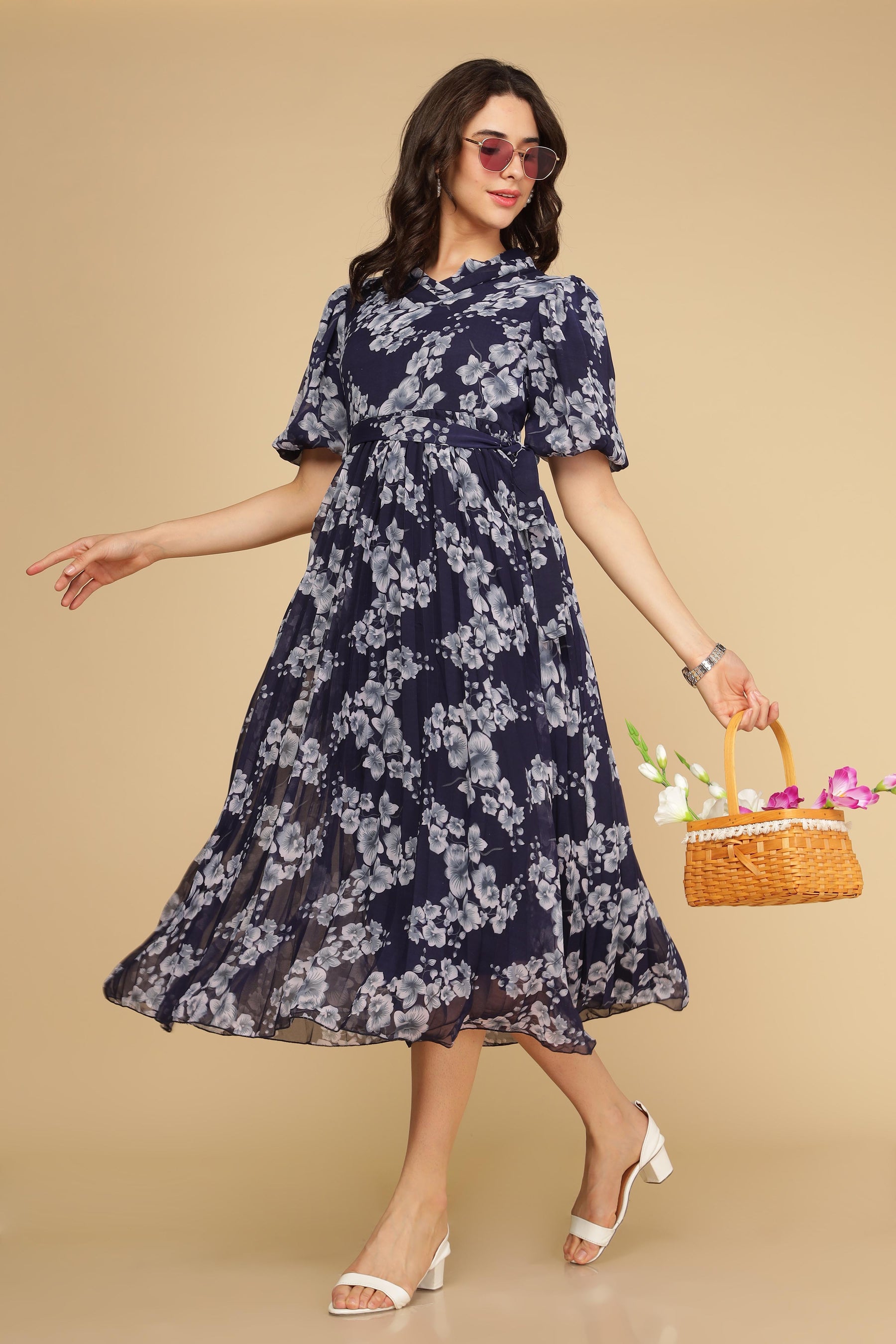 Navy floral pleated maxi dress with a stylish basket and sunglasses.