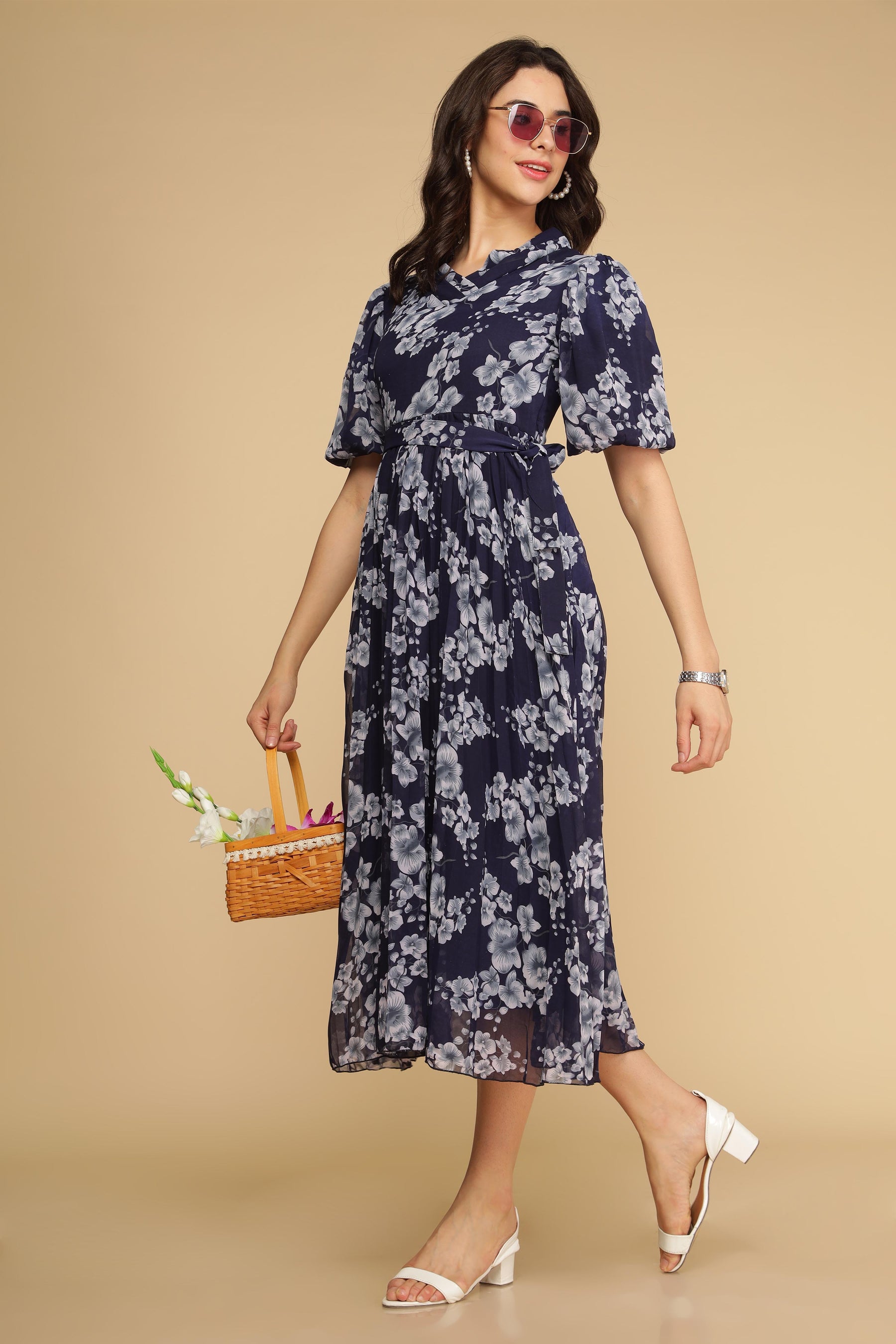 Navy floral pleated maxi dress with elegant design and accessories.