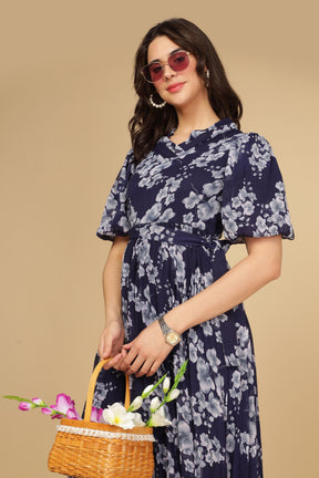 Navy floral pleated maxi dress with stylish accessories and flowers.