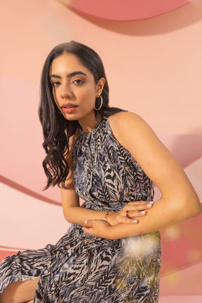 Black halter neck maxi dress model posing with stylish accessories.