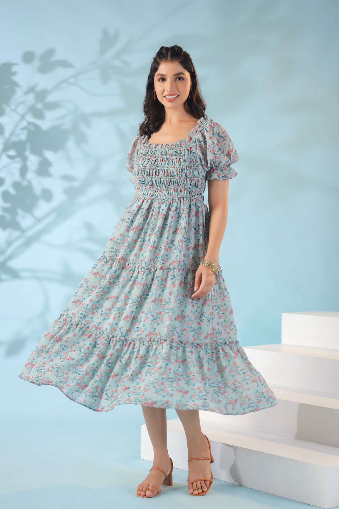 Pastel smocked nursing maxi dress model with floral print.