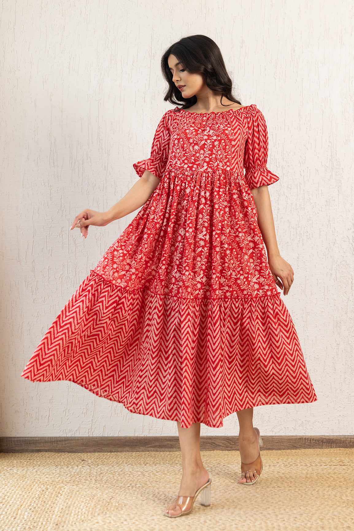 Red off-shoulder cotton maxi dress with floral and chevron patterns.