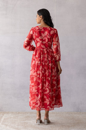 Dark red chiffon maxi dress with floral print, back view.