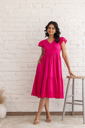 Stylish pink Schifilli cotton dress with flared skirt and pockets.