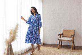 Stylish blue and white cotton maxi dress in bright room.