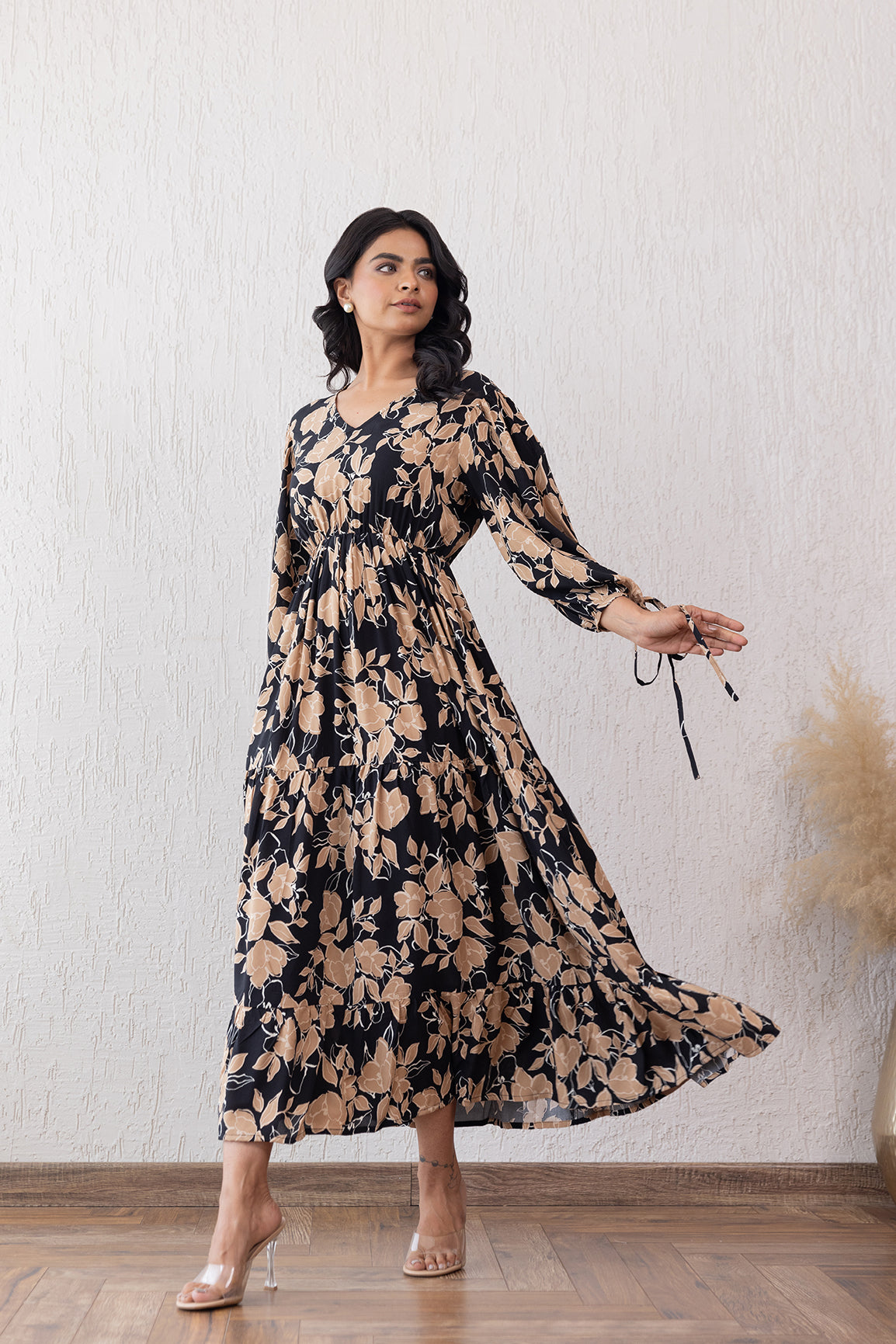 Elegant black and beige floral maxi dress with long sleeves.