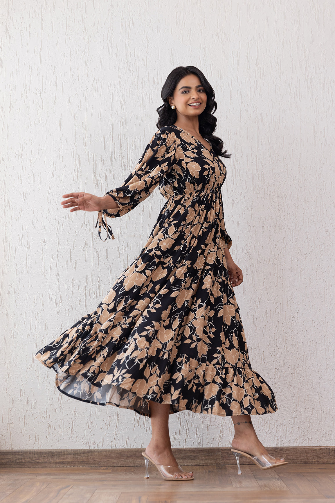 Elegant black and beige floral maxi dress on a model.